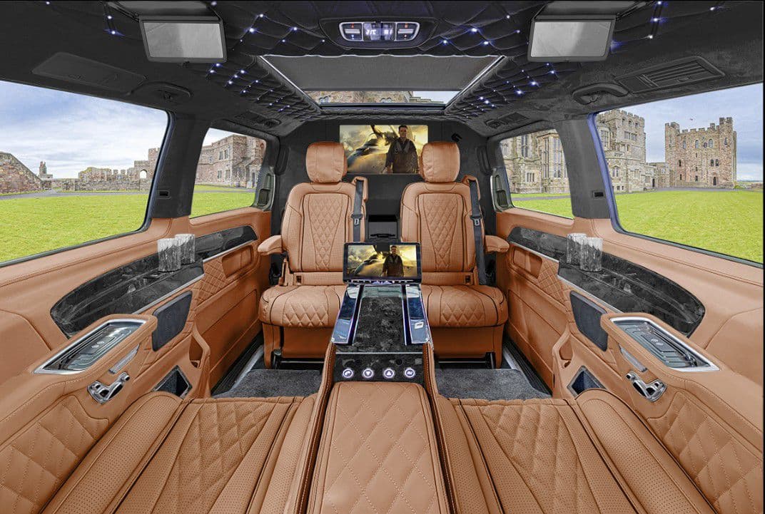 VIP van interior with tan leather, starlight ceiling and dual entertainment screens